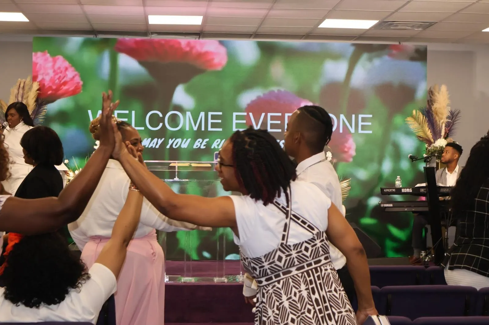 Two members of the congregation greeting each other